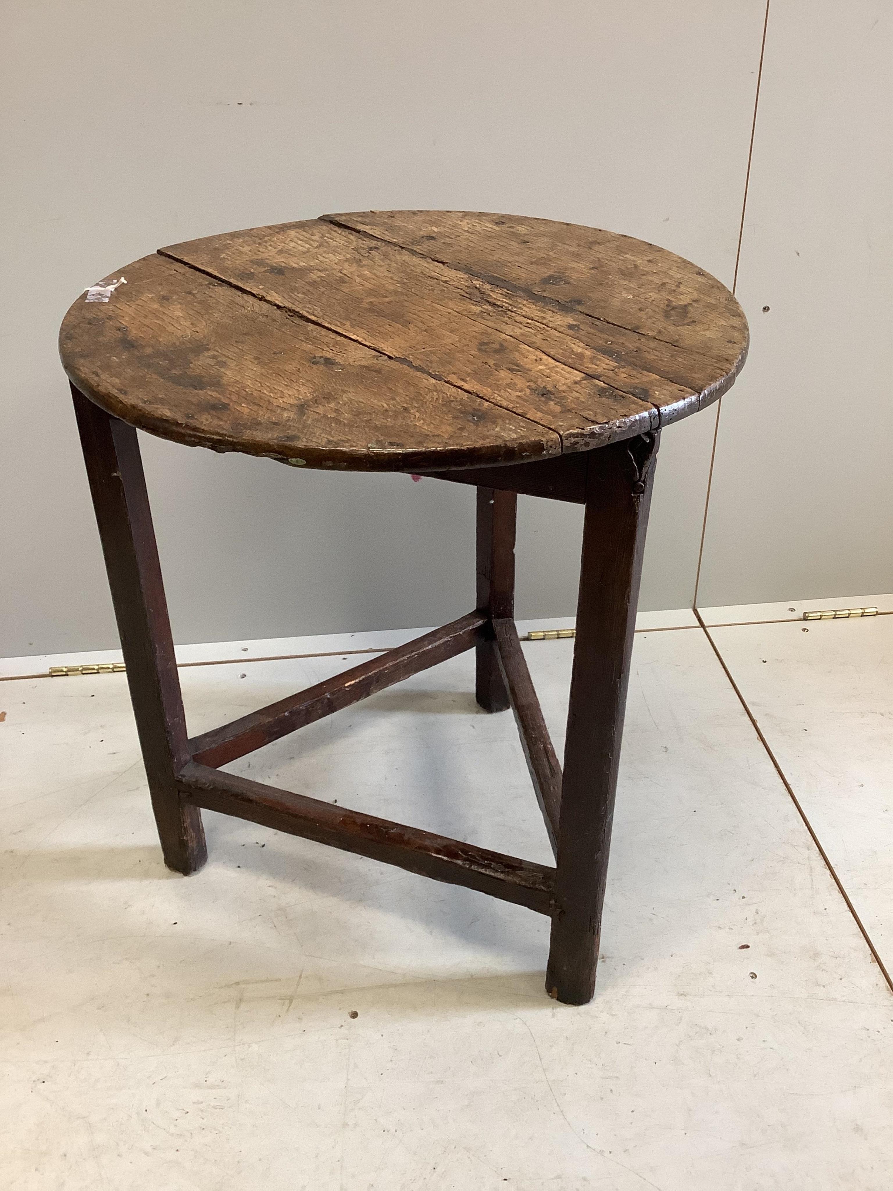 An 18th century circular oak and pine cricket table, diameter 57cm, height 63cm, together with an 18th century oak and fruitwood dining chair. Condition - poor to fair